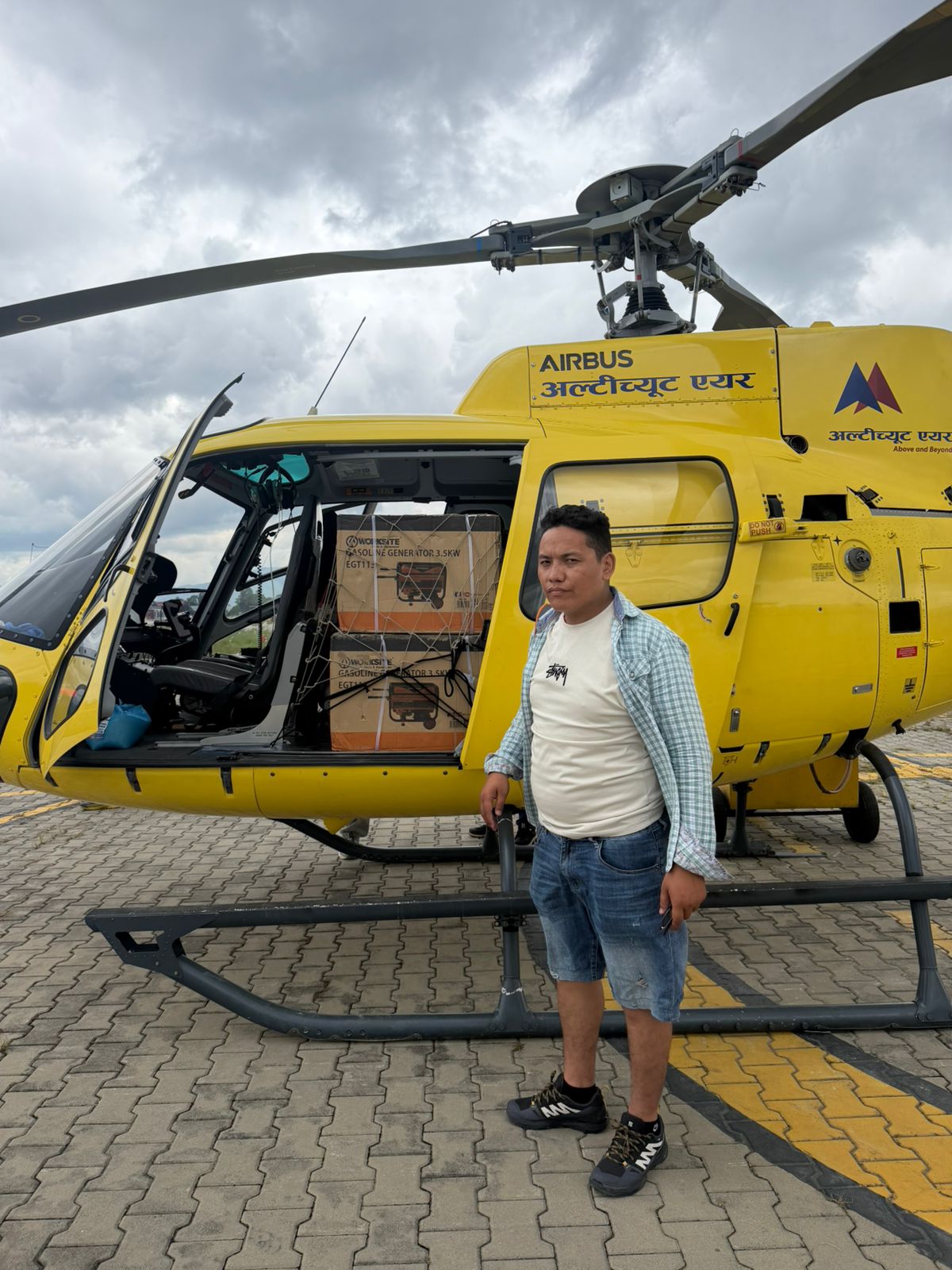 Generator cartons loaded into the cabin of a helicopter on the tarmac in Kathmandu